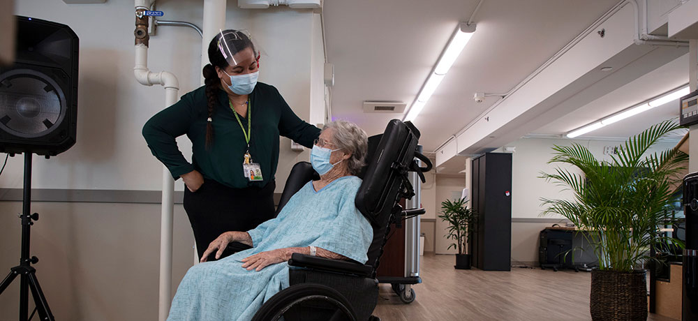 Hospice Nurse Talking with Elderly Lady in Broda Wheelchair