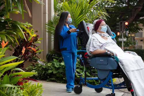Nurse Pushing Patient in Broda Wheelchair