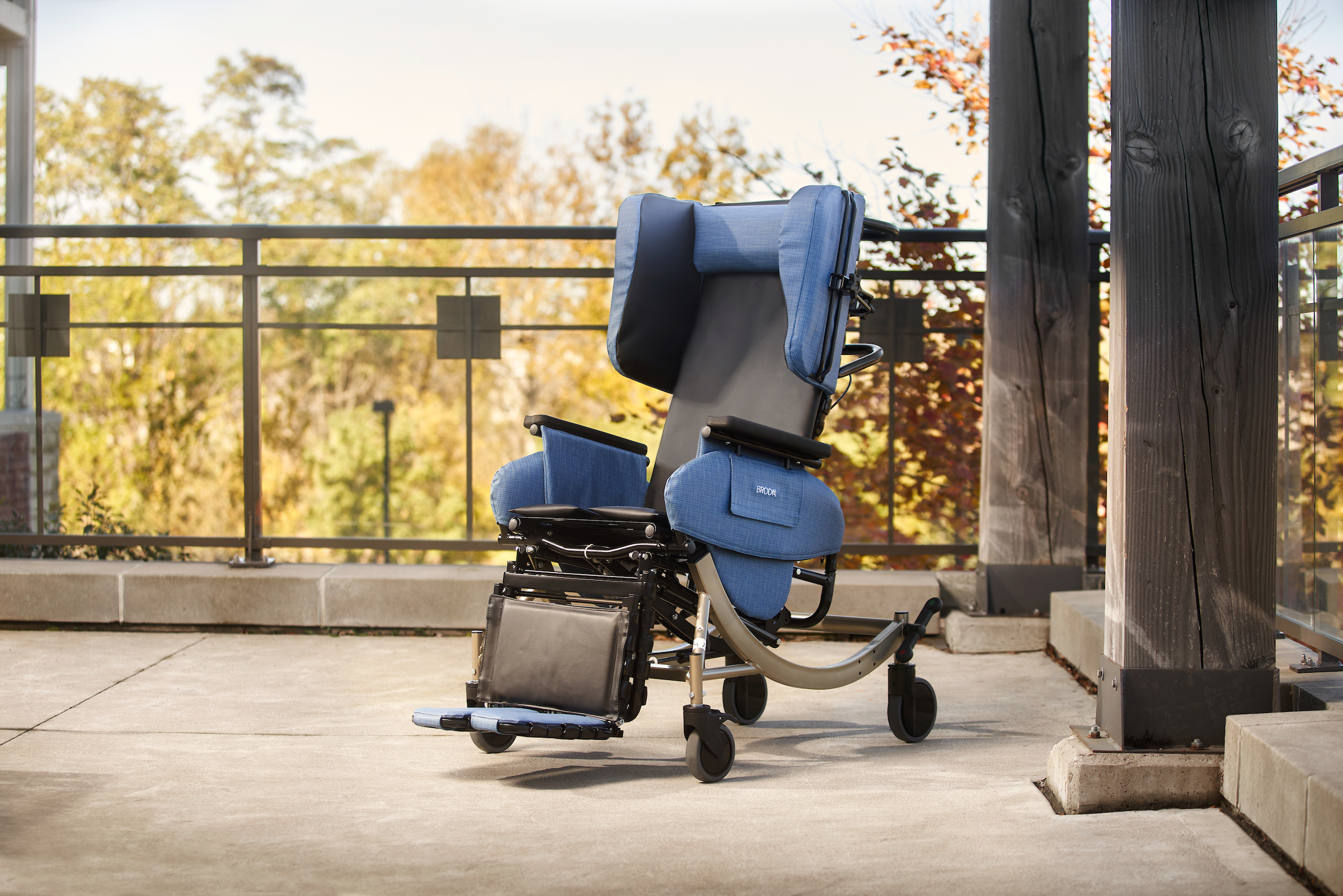 Blue Broda wheelchair on an outside balcony