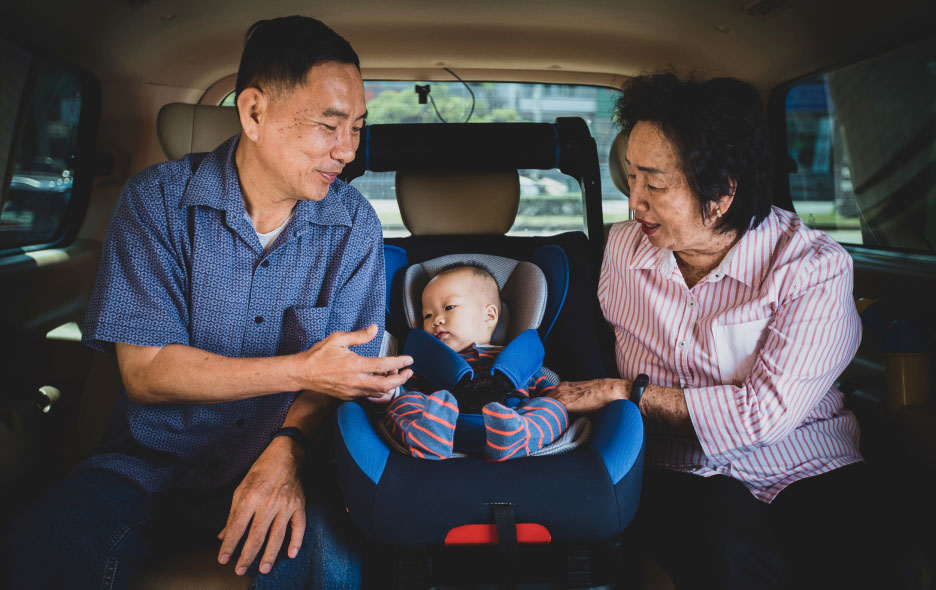 Baby in Childseat with Grandparents on Each Side