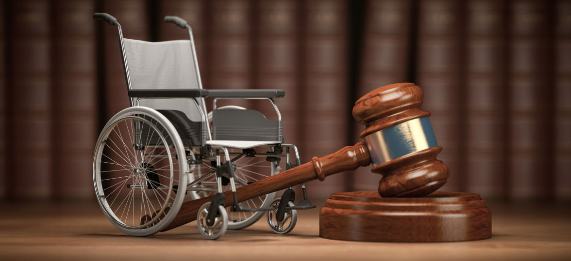 Tiny Wheelchair Positioned Next to a Courtroom Gavel