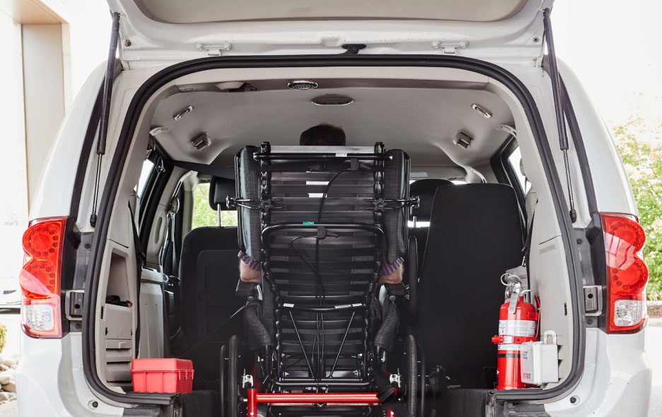 Person In Wheelchair in Back of Transport Van