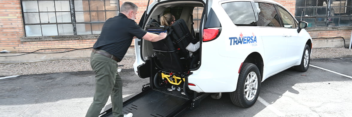 NEMT operator loading a passenger into the vehicle