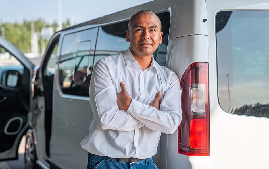 Man leaning against a transport vehicle