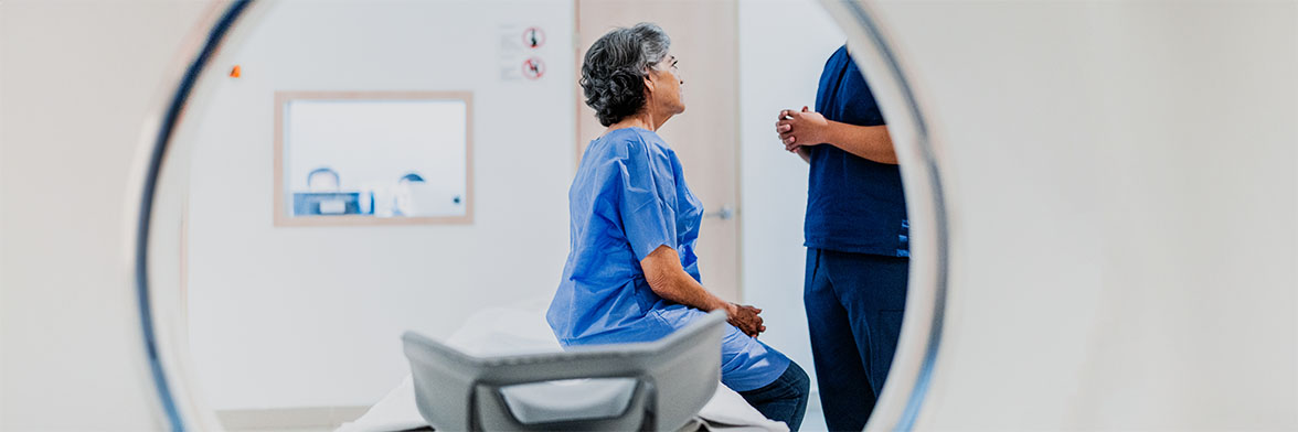 View of a patient sitting at a CT scan machine