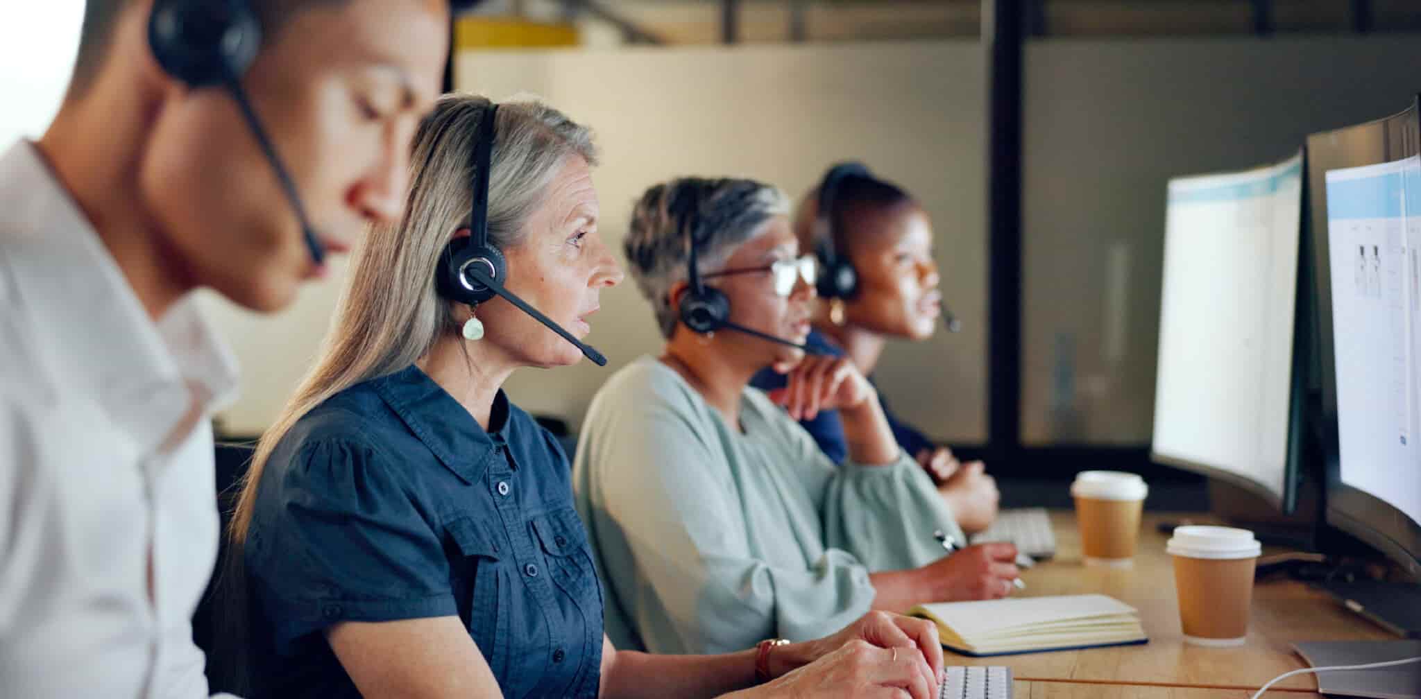 Four customer service agents in a call center.