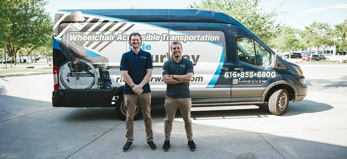 Photo of Tom and a business partner in front of a Ride Your Way van