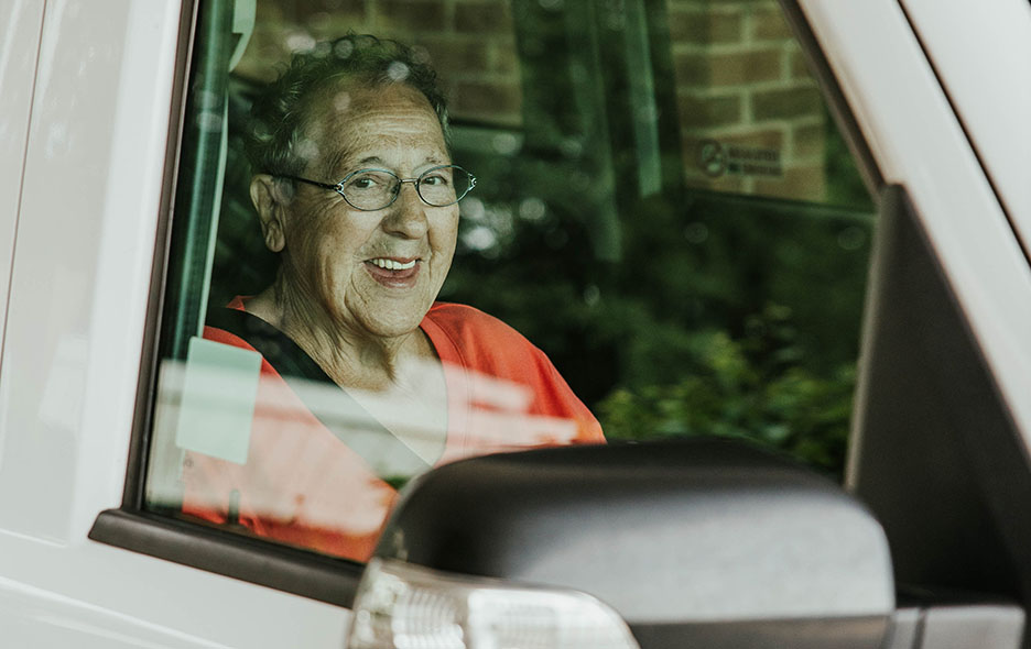 Image of a passenger seating in the front of a Ride Your Way van