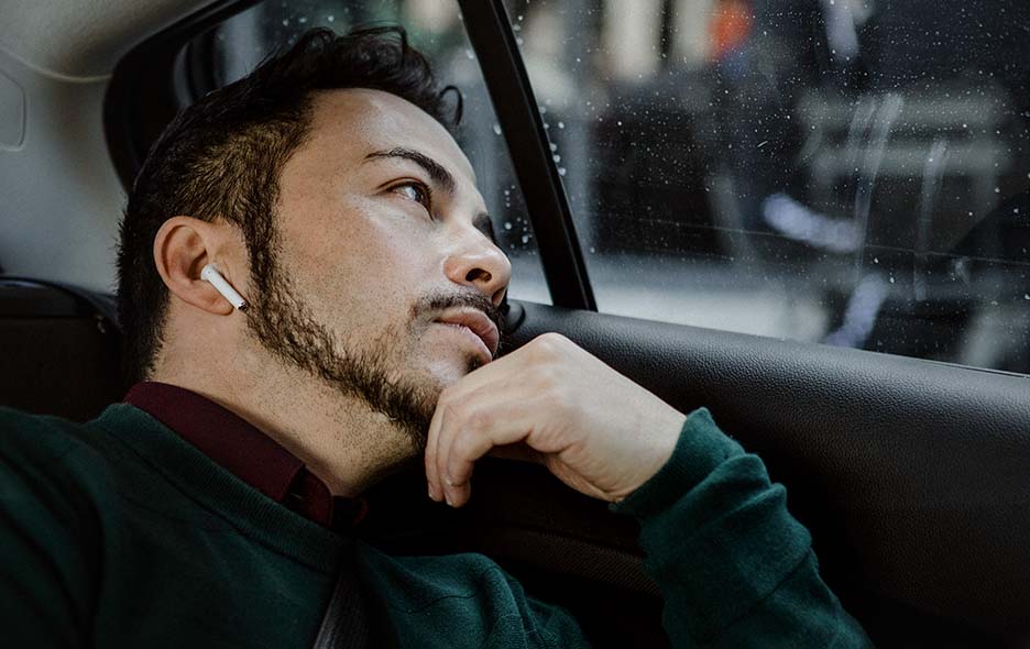 Young man looking out the car window