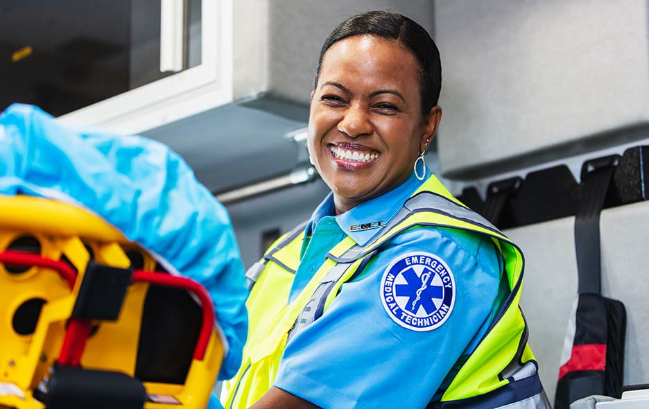 an EMT in uniform, smiling