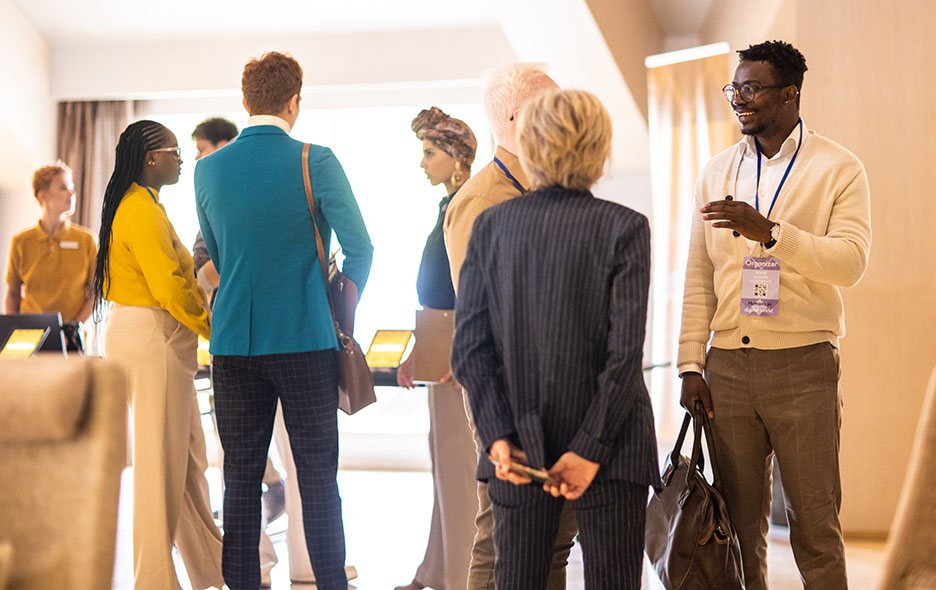 people standing and talking at a networking event