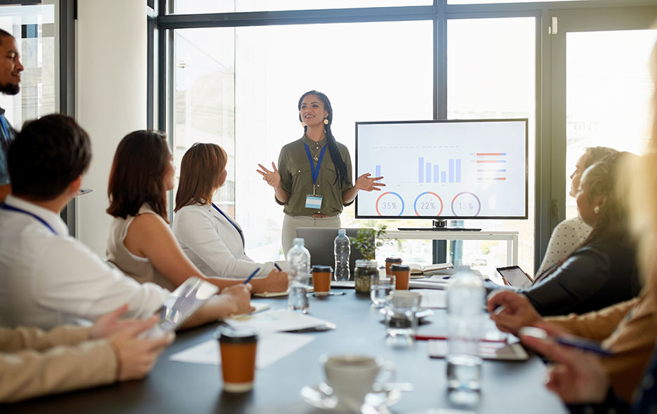 a business woman presenting to a small meeting