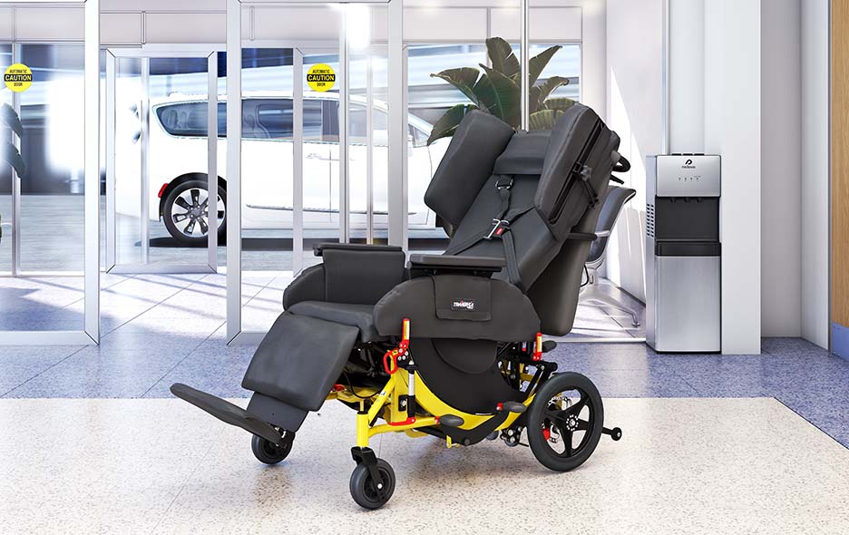 A Traversa Transport Chair in a hospital lobby with an NEMT vehicle in the background