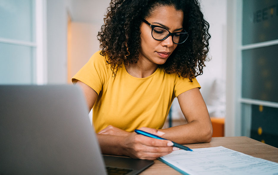 Young business person filling out paperwork