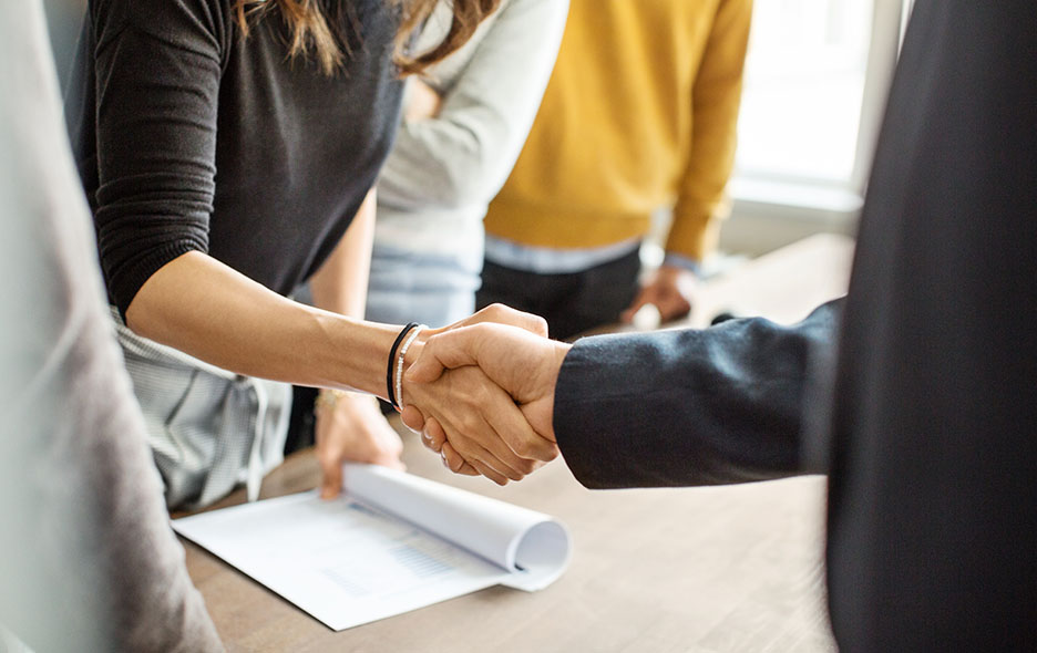 Business professionals mingling and shaking hands