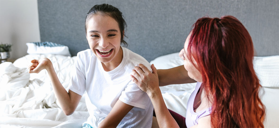 Playful young woman with cerebral palsy and her mother