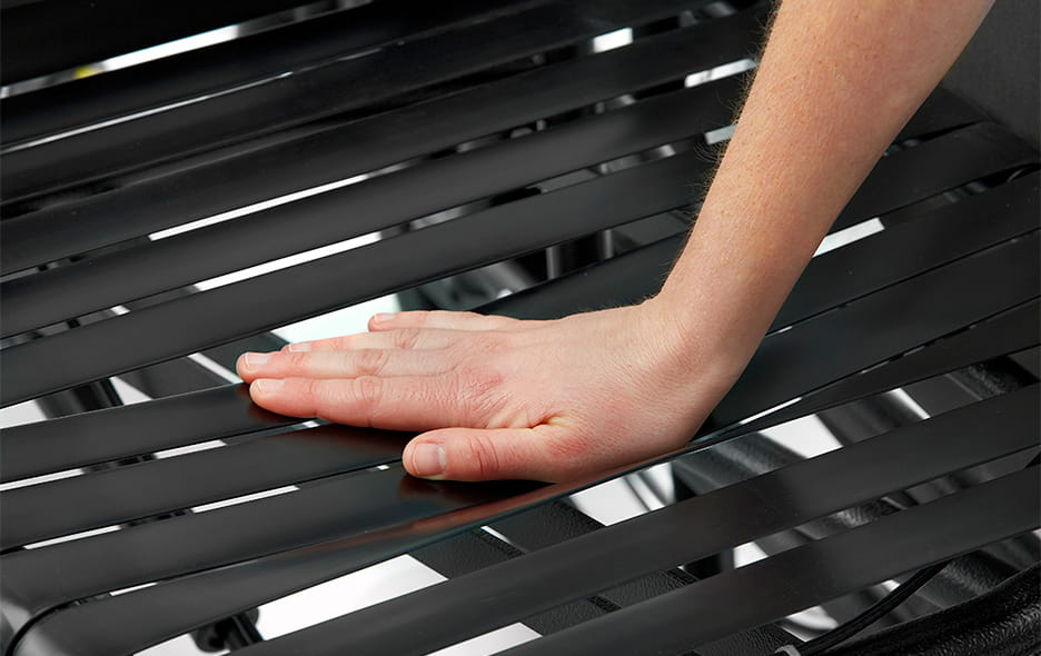 close up of a hand pressing on Broda's Comfort Tension Seating