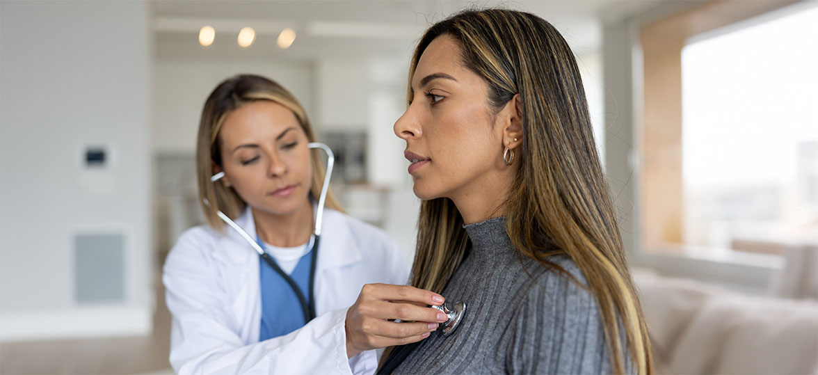 Doctor checking the pulse of a young woman