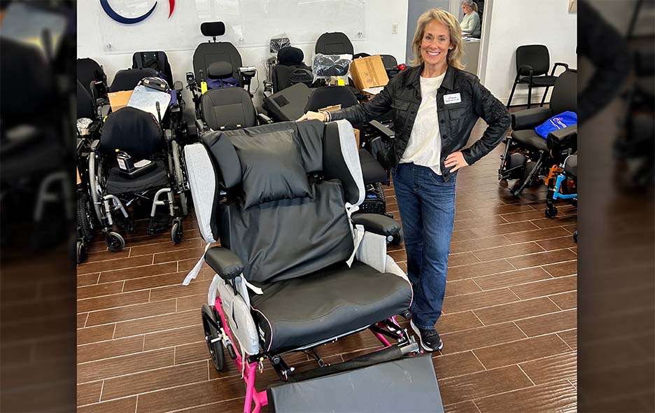 Wendy smiling with her team's Broda Synthesis wheelchair