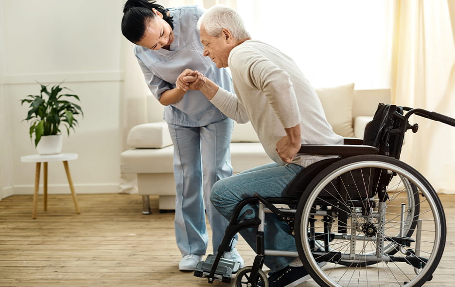 Caregiver helping a patient position in their wheelchair