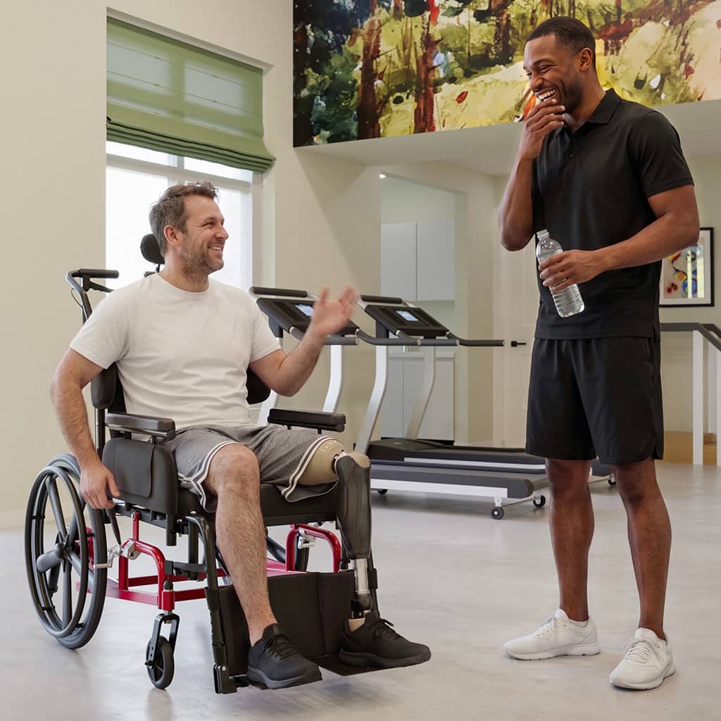 Man in a Comfort Rehab wheelchair interacting with his caregiver