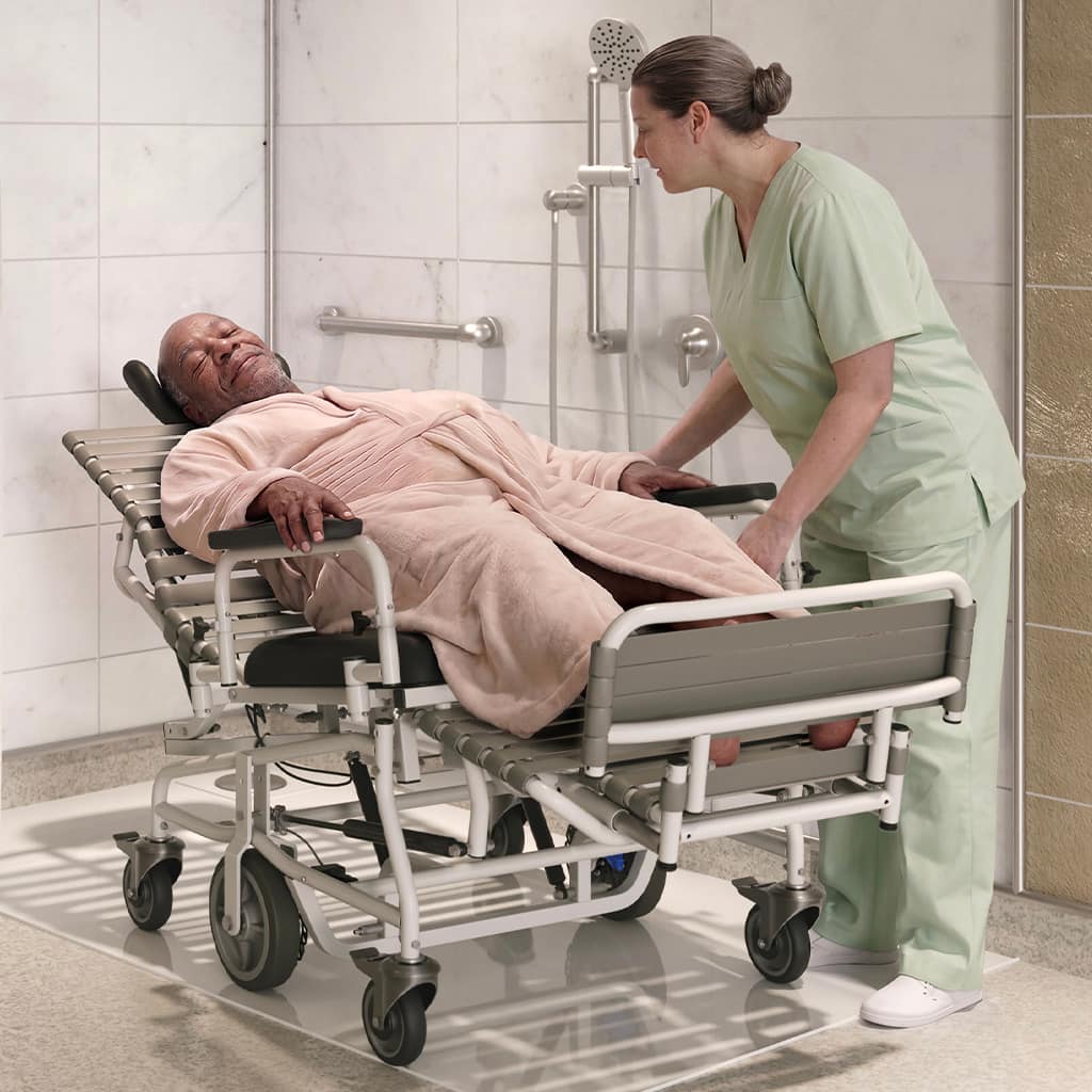Caregiver helping a senior man in a shower setting