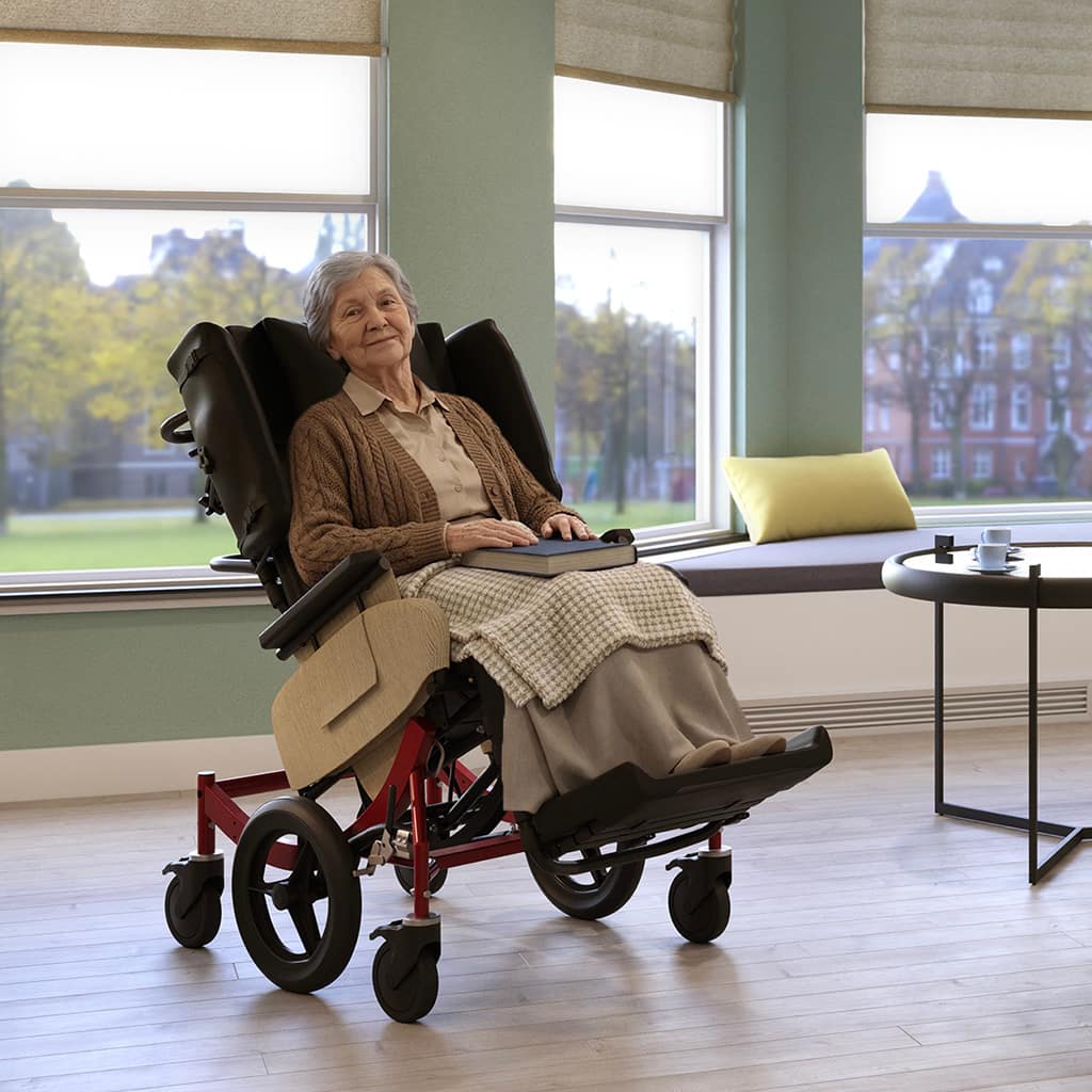 Senior woman reclined in a wheelchair with a book in her lap