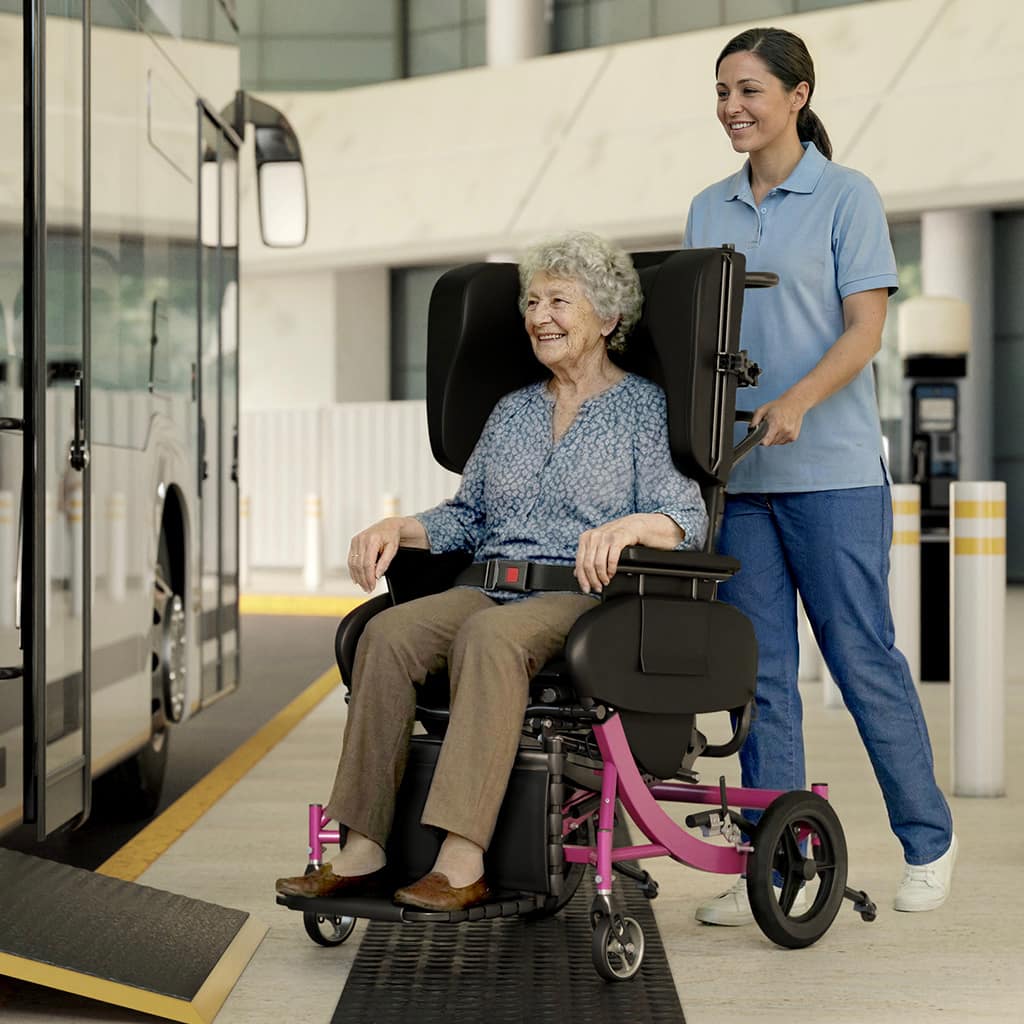 Caregiver ushering a patient to a bus