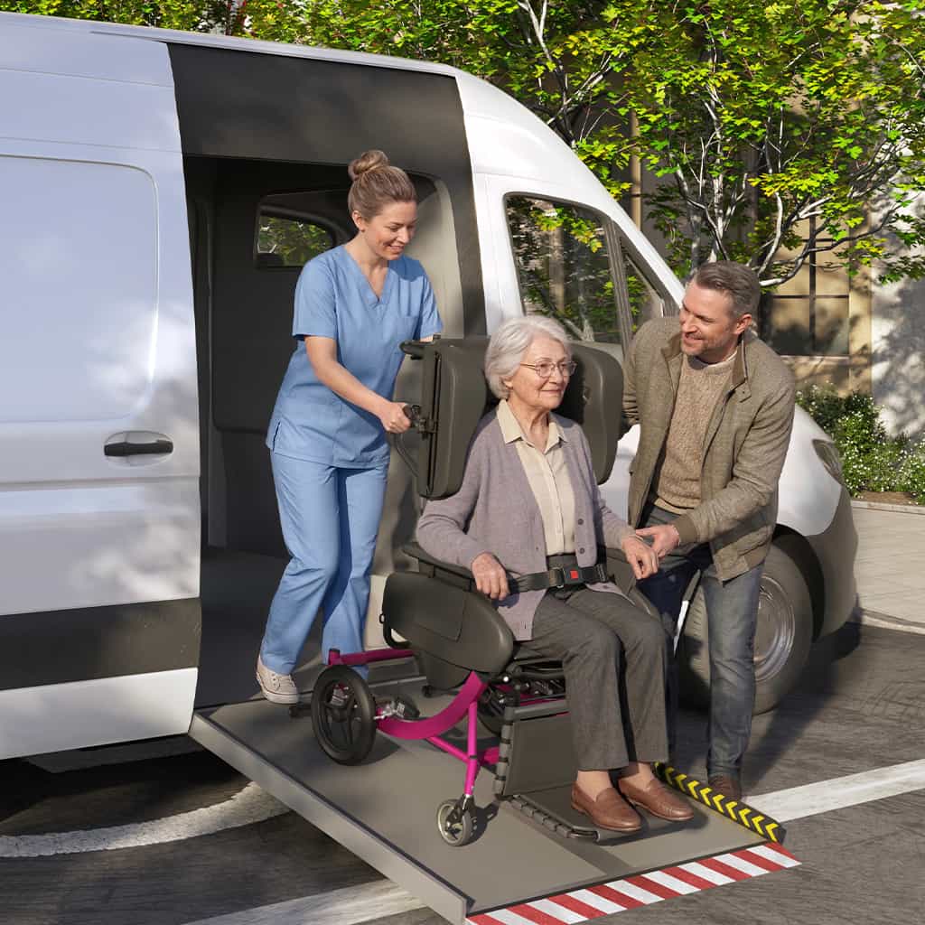 Caregiver and family member helping the a senior woman out of a transport vehicle